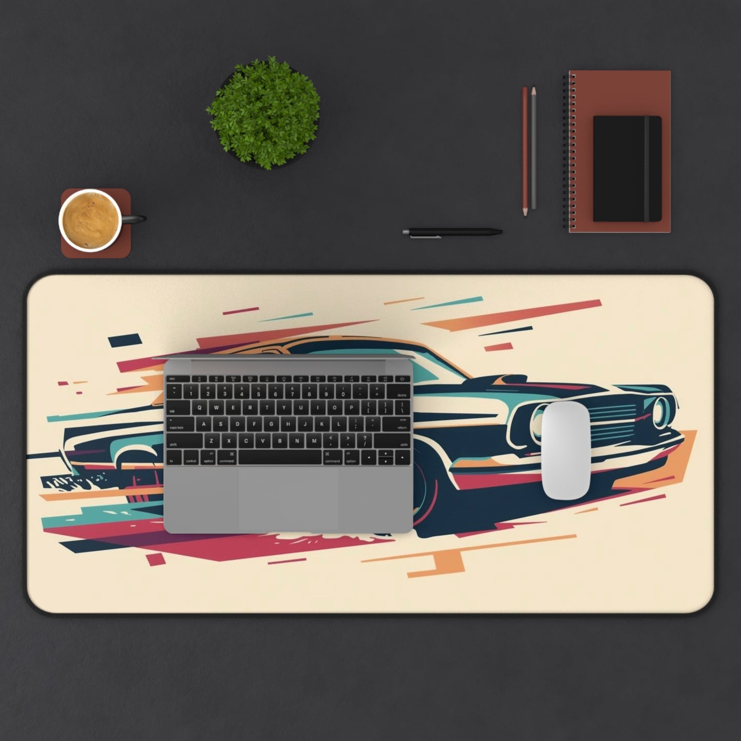 Desk setup with a desk mat featuring a car design, keyboard, mouse, and office supplies on a dark surface.
