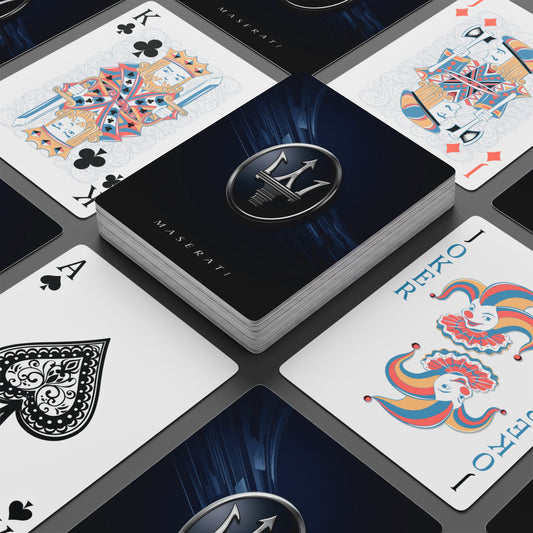 Playing cards with Maserati logo and branding on a dark surface