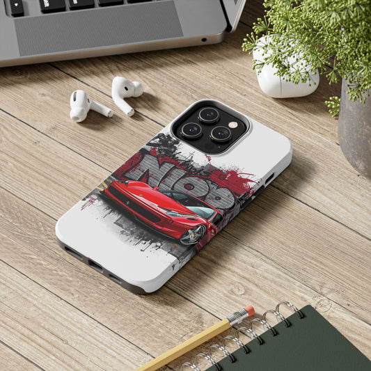 Phone case with red car design on a wooden surface with laptop, earbuds, and notebook.