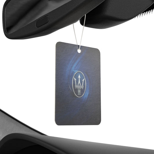 Car air freshener with Maserati logo hanging from a car's rearview mirror.