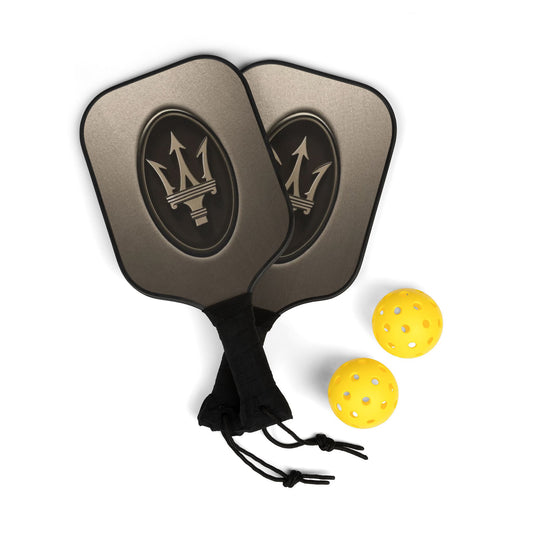 Two pickleball paddles with a logo and three yellow pickleballs on a white background