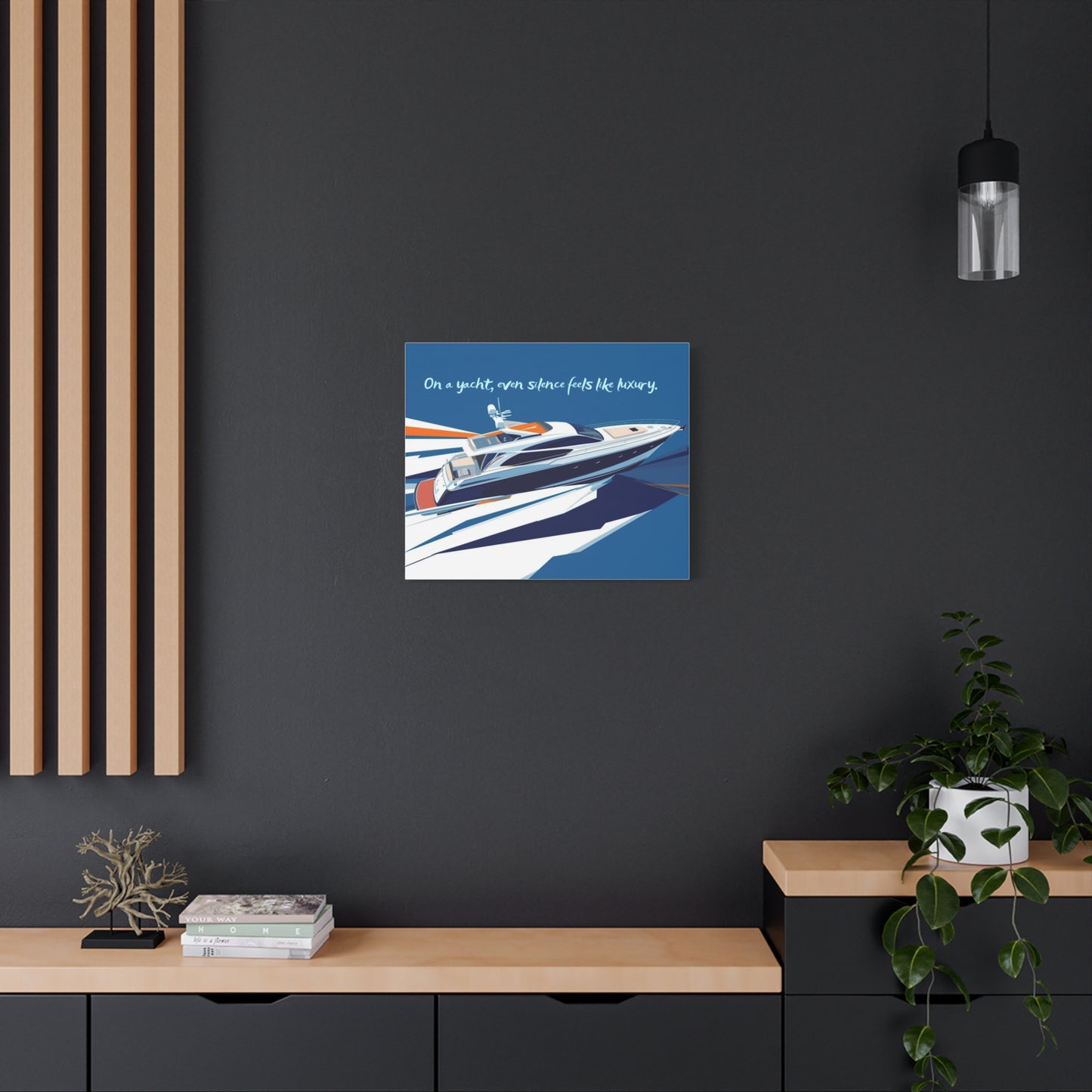 Canvas wall art of a yacht on a dark wall with decorative elements below.