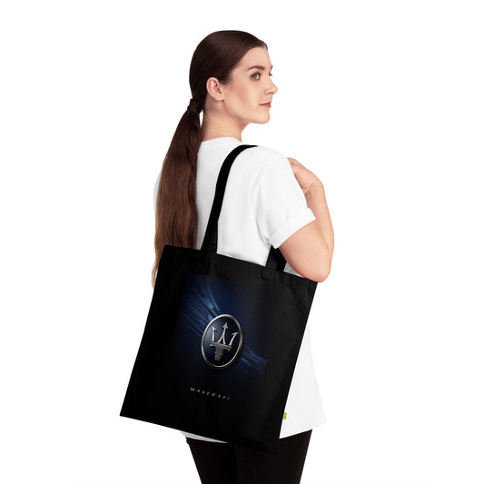 Woman carrying a black tote bag with a logo on a white background