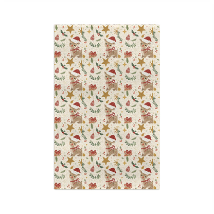 Christmas-themed patterned kitchen towel with reindeer, stars, and bows on a white background