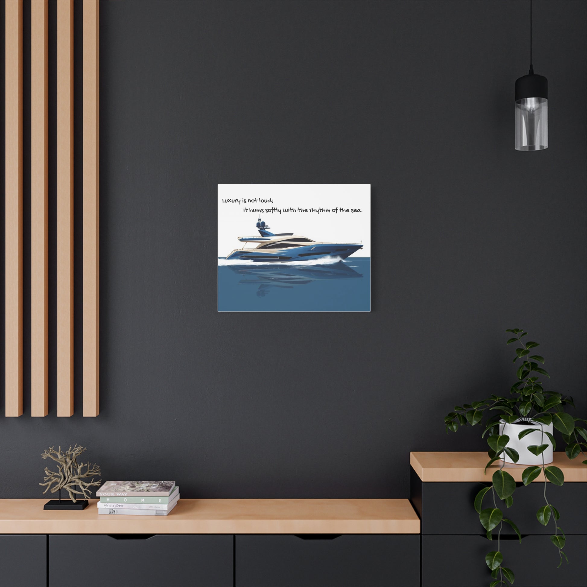 Wall art canvas of a Yacht on water with text, displayed on a dark wall above a wooden shelf.