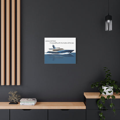 Wall art canvas of a Yacht on water with text, displayed on a dark wall above a wooden shelf.