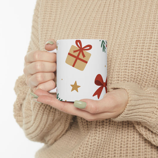 Person holding a mug with Christmas-themed designs against a beige sweater background