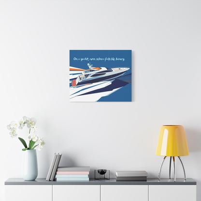 Canvas wall art of a yacht on a white wall above a shelf with decor items.