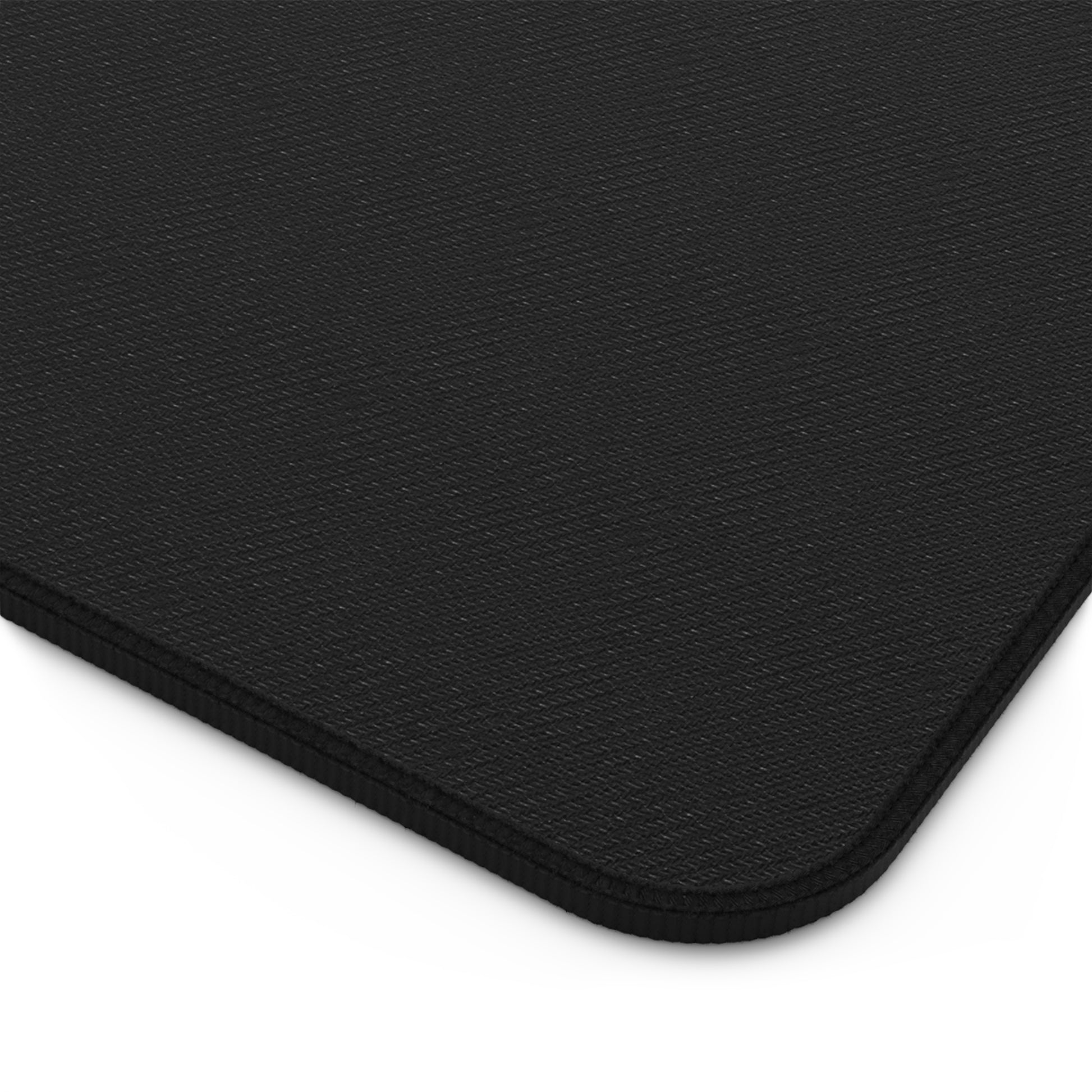 Close-up of a non-slip black backing mouse pad with a textured surface. 