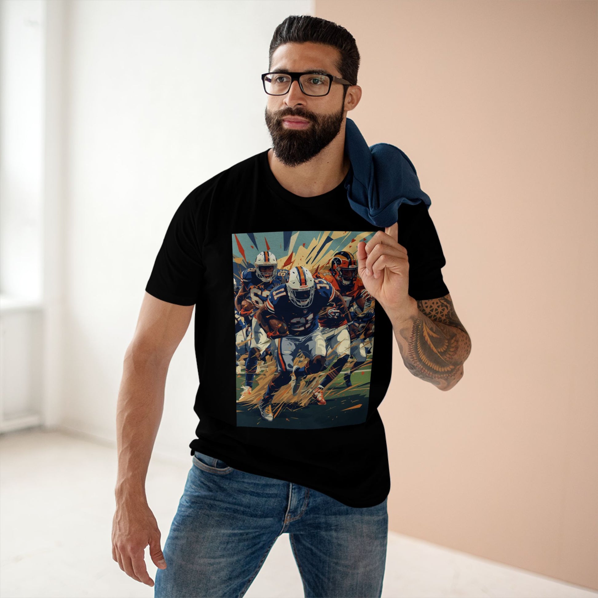 Man wearing a black t-shirt with a graphic design of a football player, standing indoors.