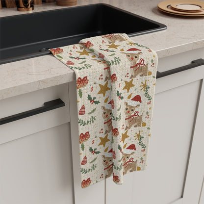 Decorative kitchen towel with Christmas patterns hanging over a kitchen counter.