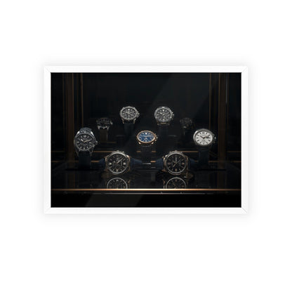 Collection of watches displayed in a dark glass case with a white border.
