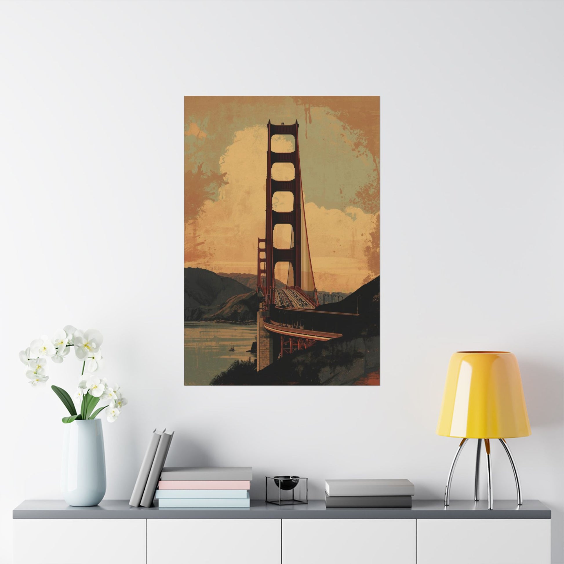 Poster of the Golden Gate Bridge on a wall above a shelf with decor items.