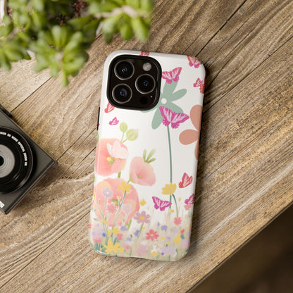 Phone case with floral design on a wooden surface next to a camera and plant