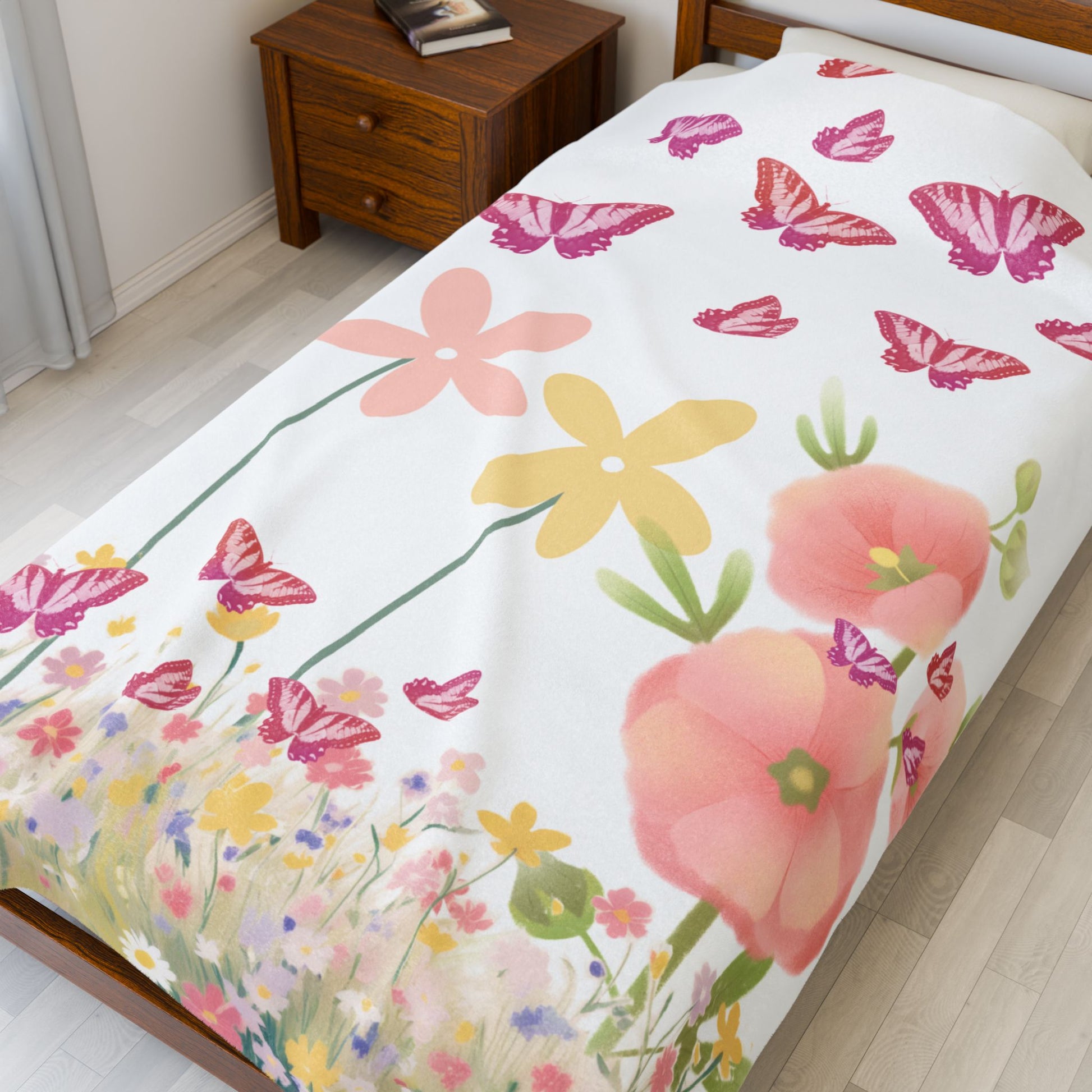 Floral and butterfly patterned blanket on a bed in a bedroom.