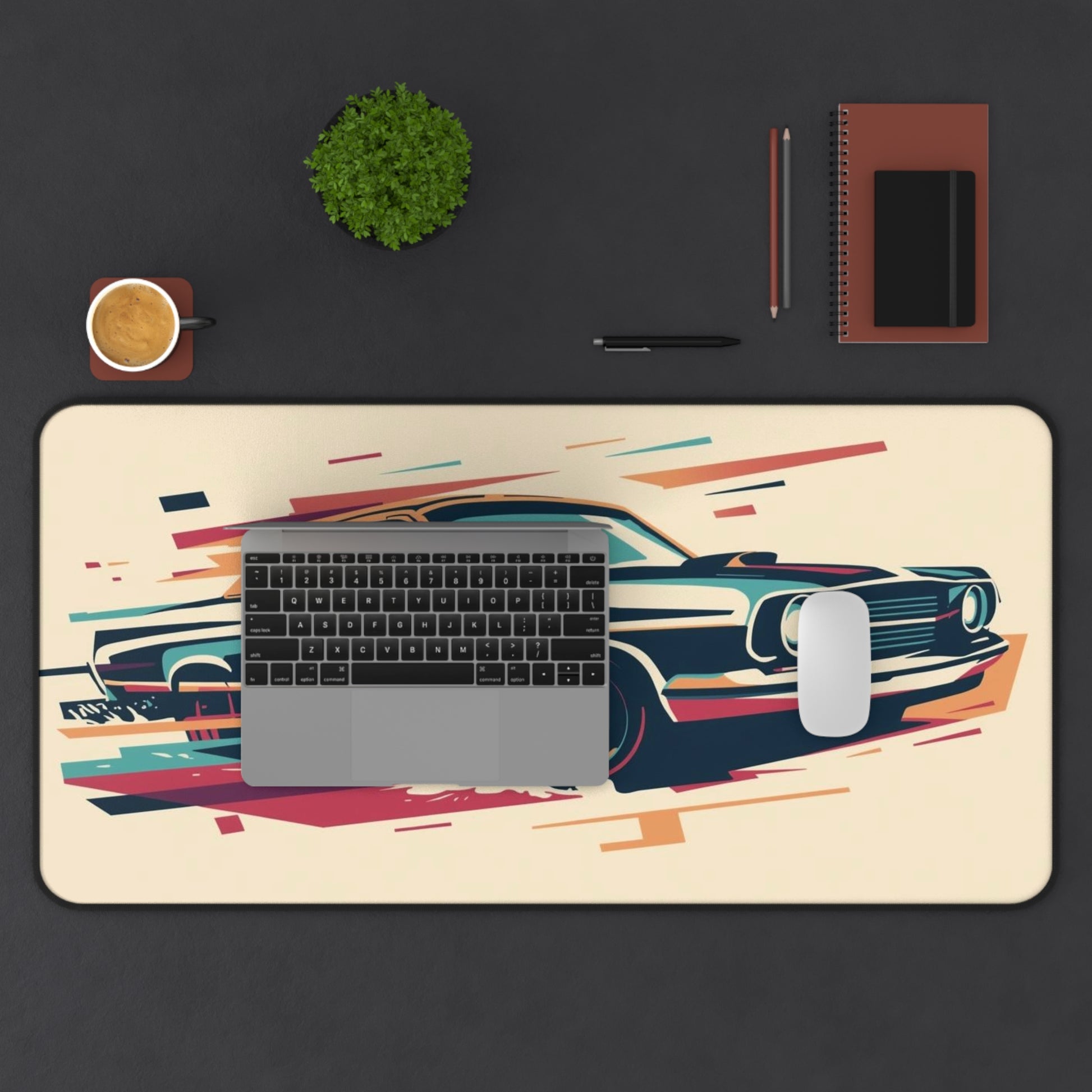 Desk setup with a desk mat featuring a car design, keyboard, mouse, and office supplies on a dark surface.