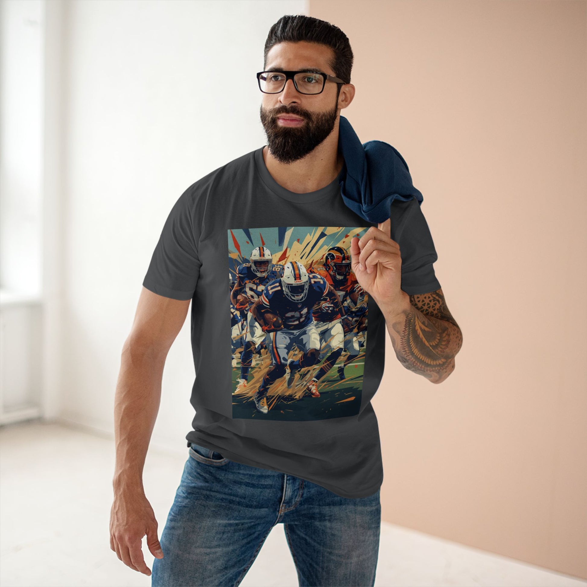 Man wearing a t-shirt with a colorful graphic design in a room with a neutral background