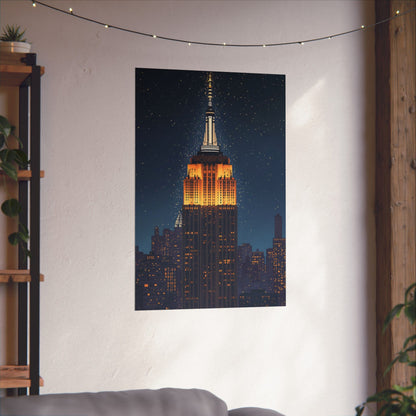 Poster of the Empire State Building on a wall in a room with a plant and shelf.