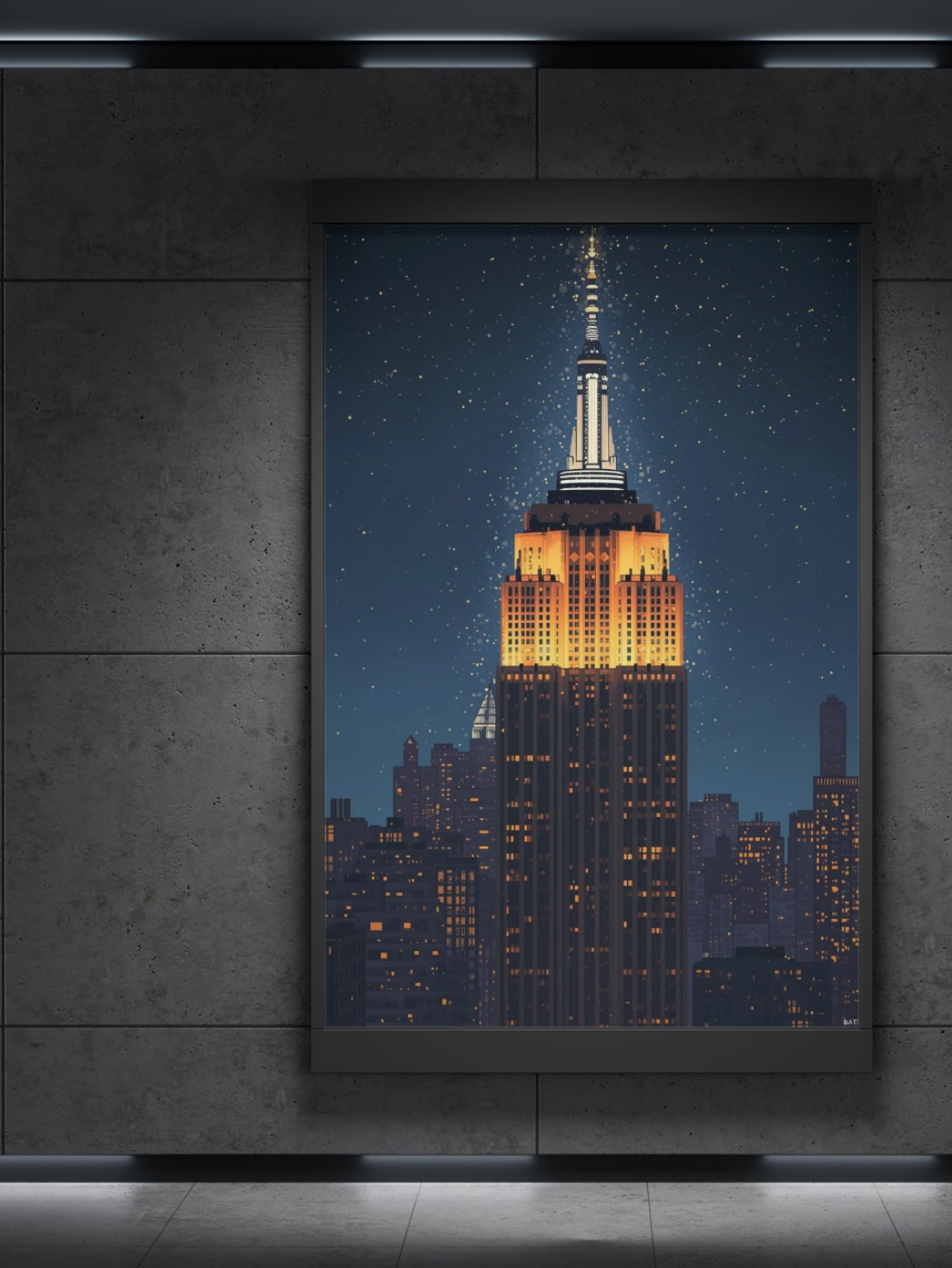 Framed artwork of the Empire State Building at night on a textured wall.