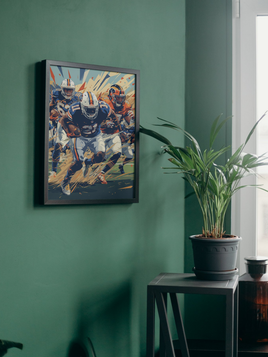 Framed artwork of football players on a green wall with a plant and stool in the foreground.