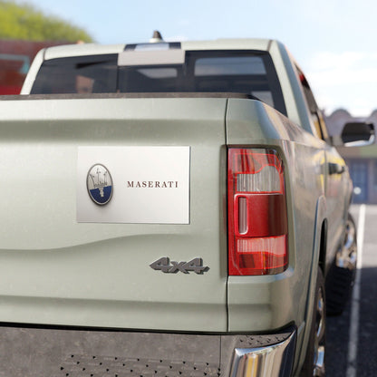 Maserati logo on a vehicle's rear, with a clear sky in the background.