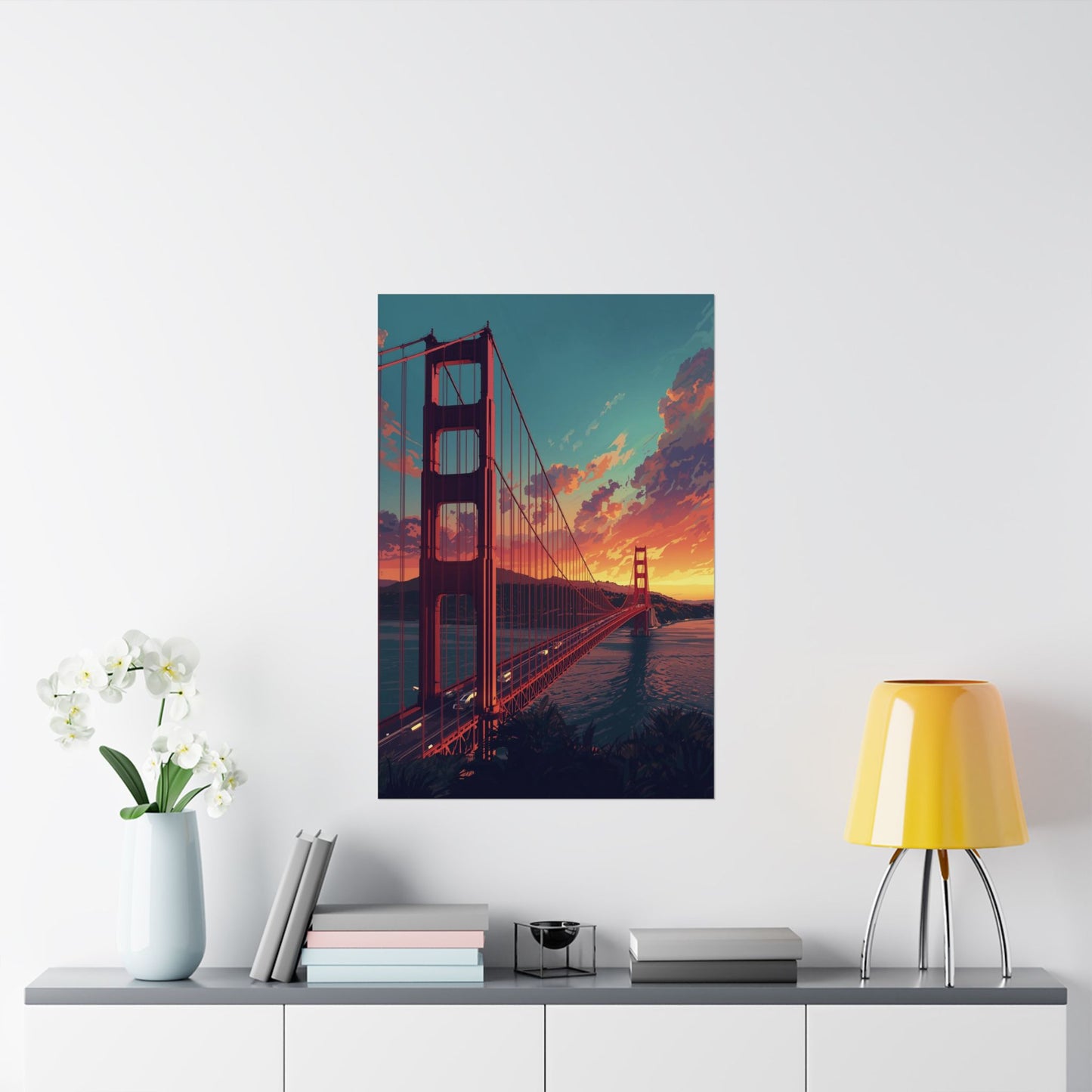 Framed artwork of the Golden Gate Bridge on a wall above a shelf with decor items.