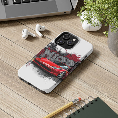 Phone case with red car design on a wooden surface with laptop, earbuds, and notebook.