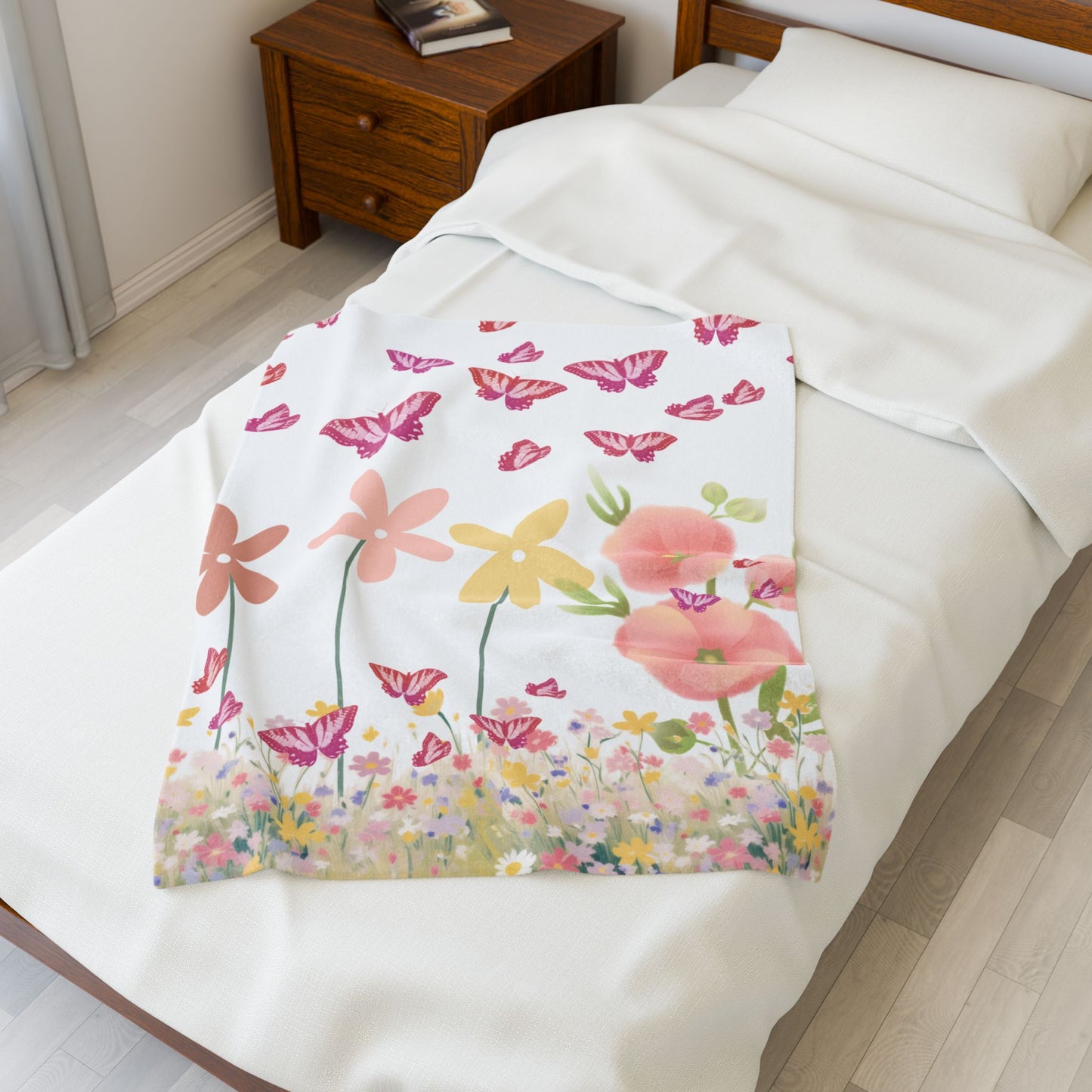 Floral patterned blanket draped over a bed in a bedroom setting.