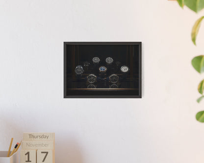 Framed artwork on a wall with a calendar and plant in the foreground