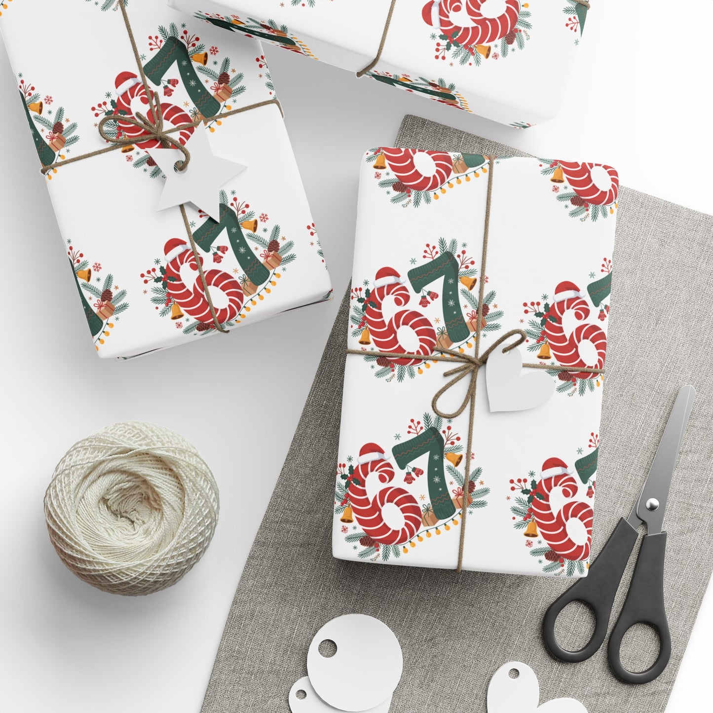 Gift wrap with candy cane and number design on a white surface with scissors and twine.