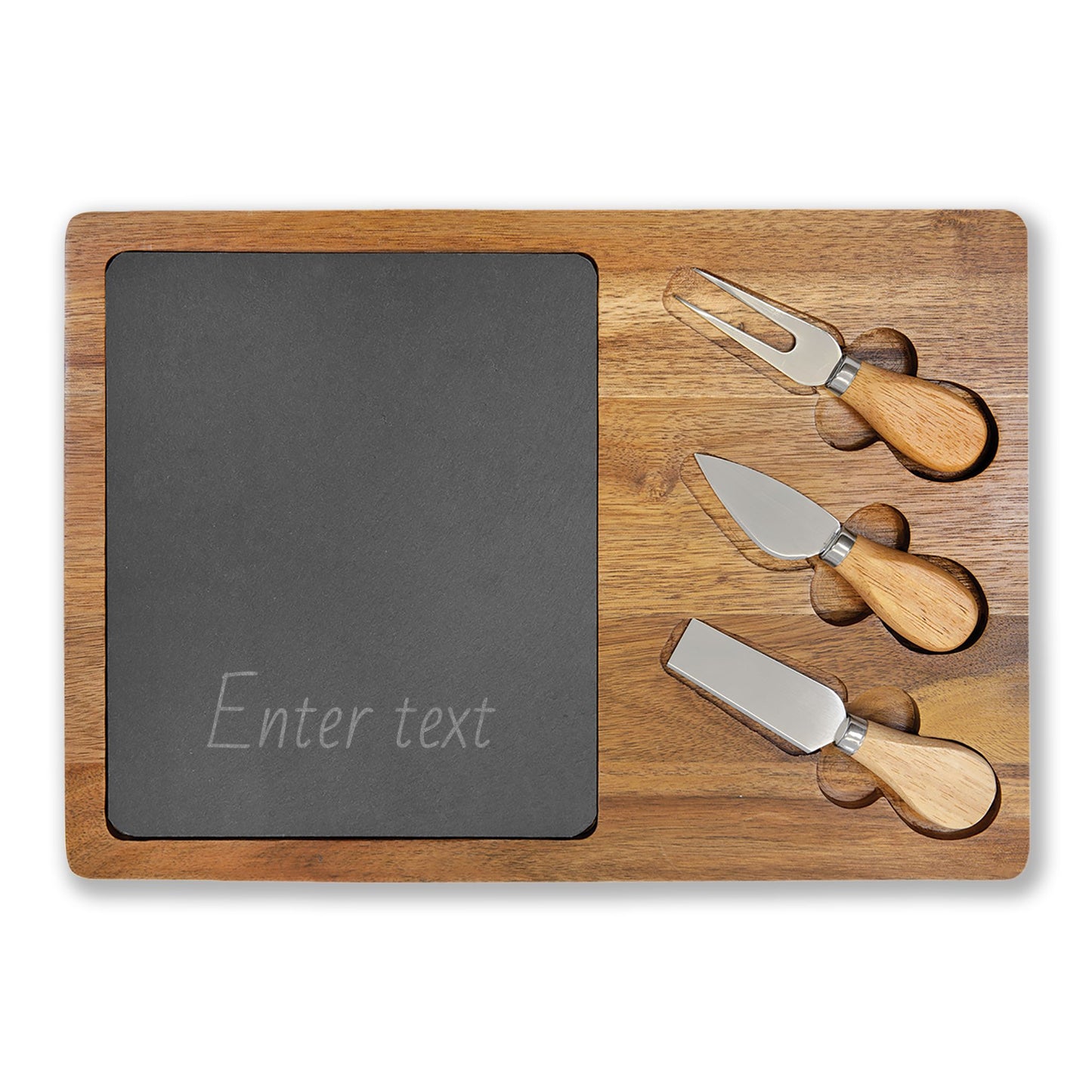 Wooden cutting board with slate surface and three cheese knives on a white background