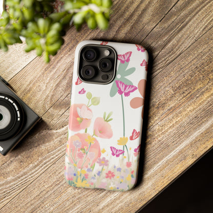 Floral phone case on a wooden surface with a camera and plant in the background
