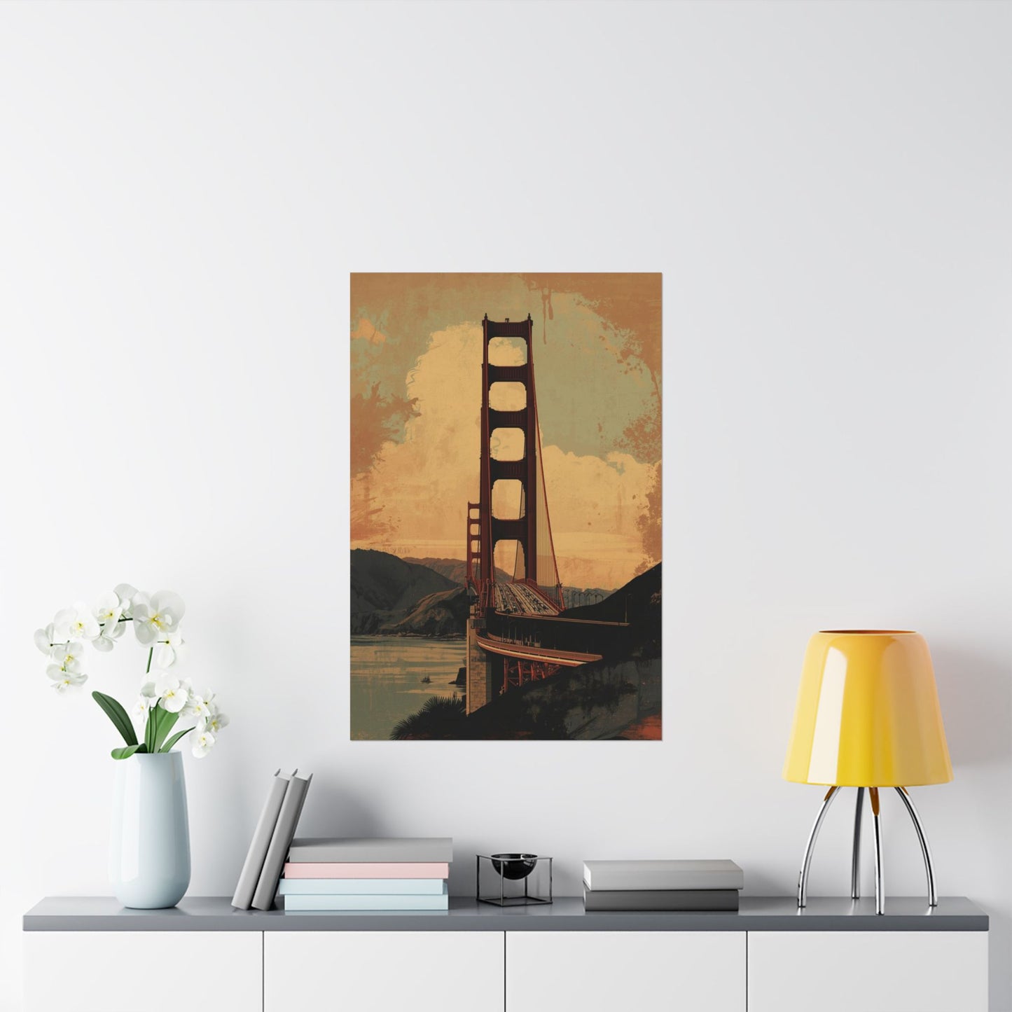Poster of the Golden Gate Bridge on a wall above a shelf with decor items.