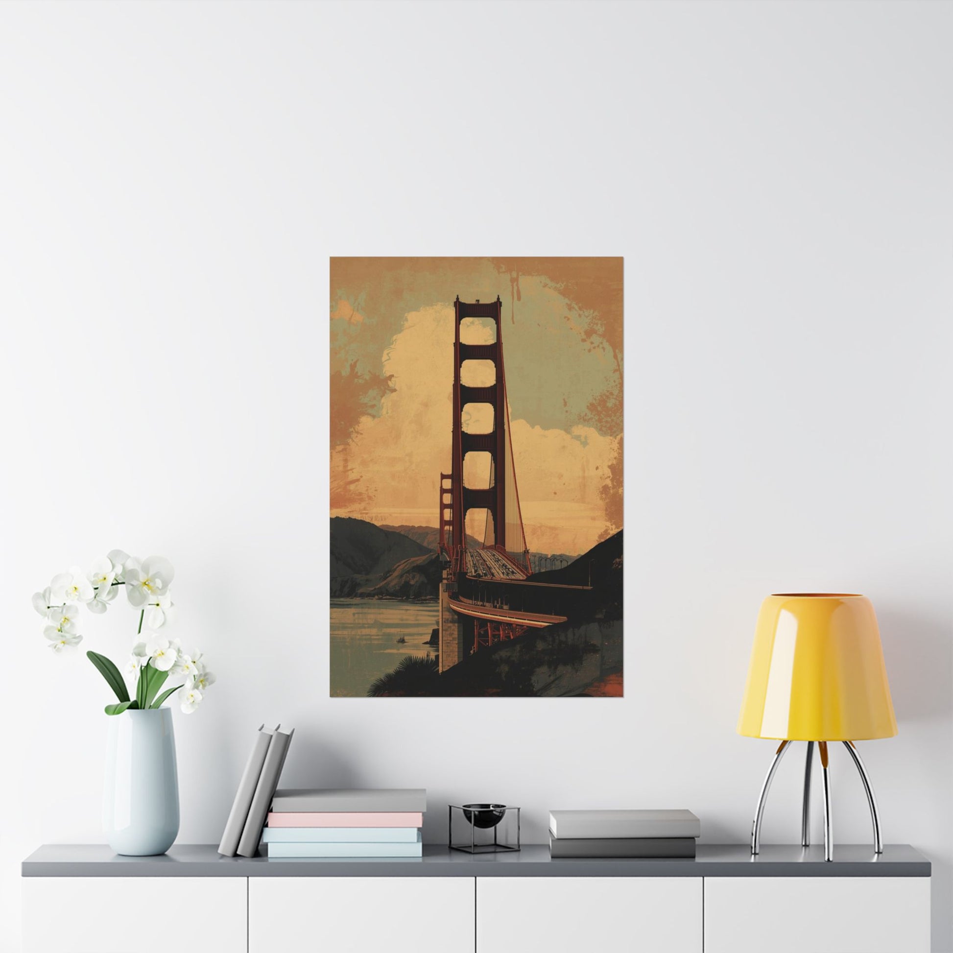 Poster of the Golden Gate Bridge on a wall above a shelf with decor items.