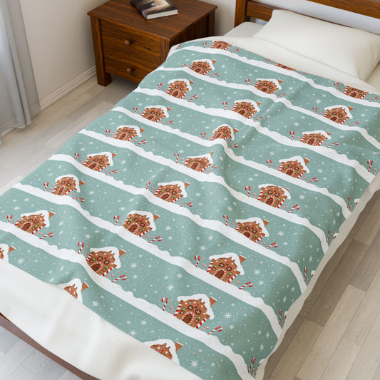 Bed with a festive gingerbread man patterned blanket in a bedroom setting.