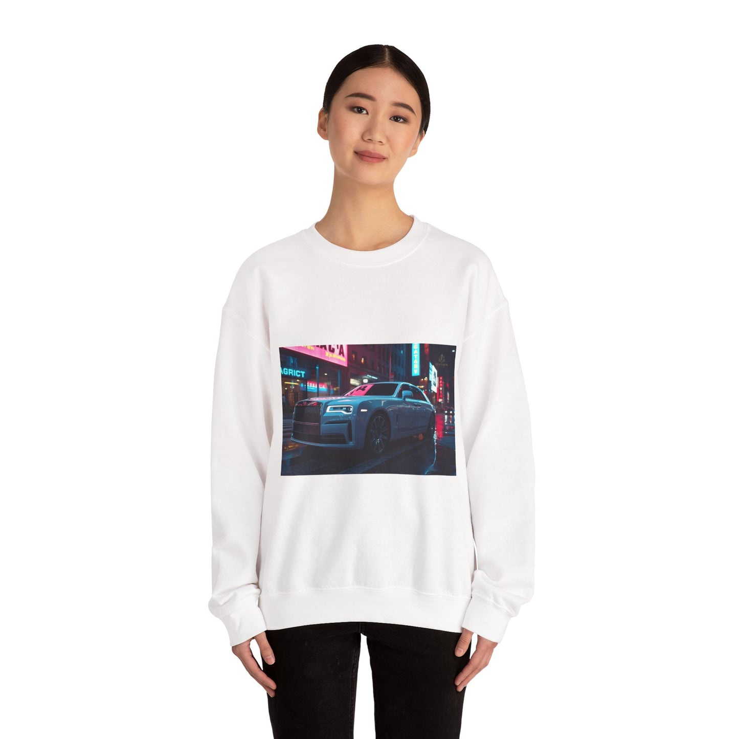 Person wearing a white sweatshirt with a graphic of a car on a city street at night.