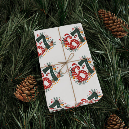 Gift wrapped in festive paper with candy cane design on a bed of pine needles.