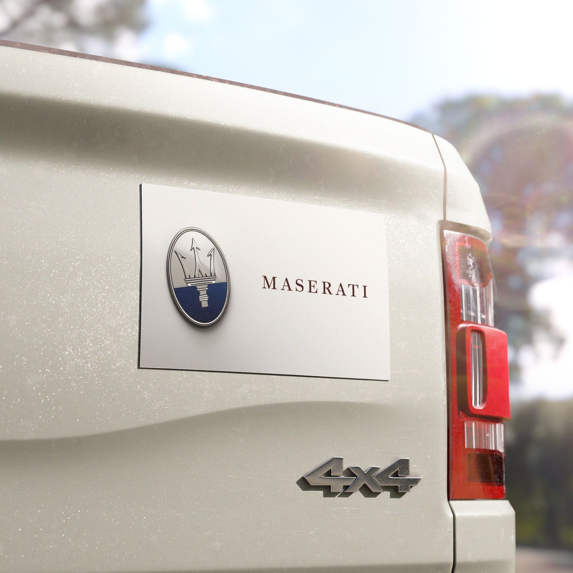 Maserati vehicle with logo and '4x4' badge on a blurred natural background